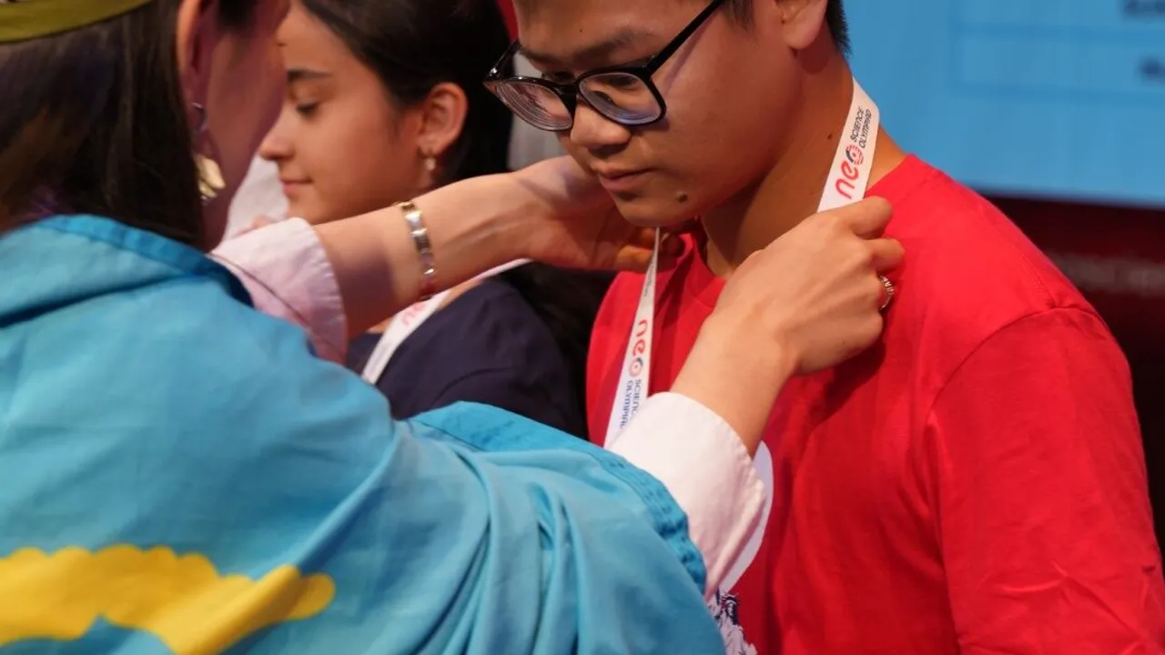 A medal being placed around a finalist's neck